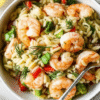Close-up of a bowl filled with vibrant Shrimp and Orzo Salad, featuring plump shrimp, orzo pasta, fresh dill, and colorful diced vegetables.